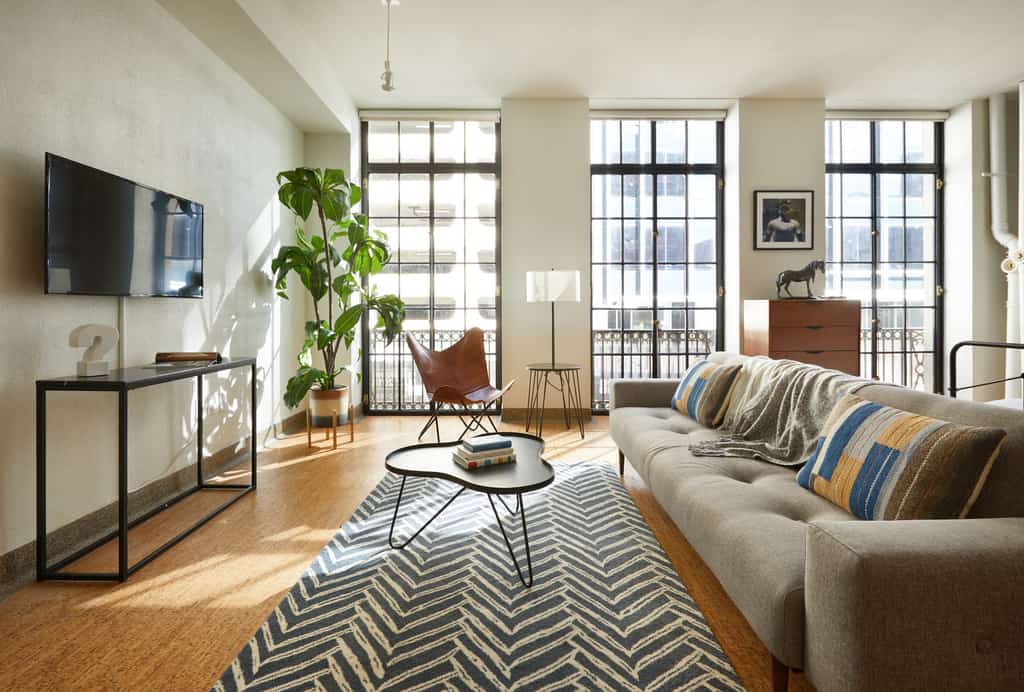 the living room of a downtown vacation condo with modern furniture