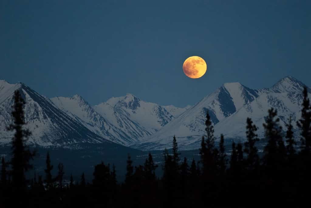 Girdwood at night with a moon