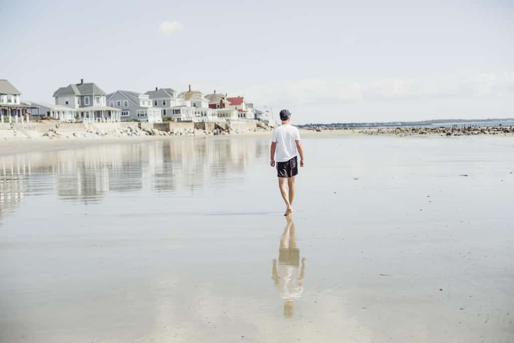 Man walking on the coast in Maine.
