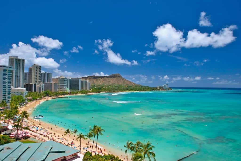 View from the deck overlooking the beach and the ocean at a vacation rental in Hawaii.