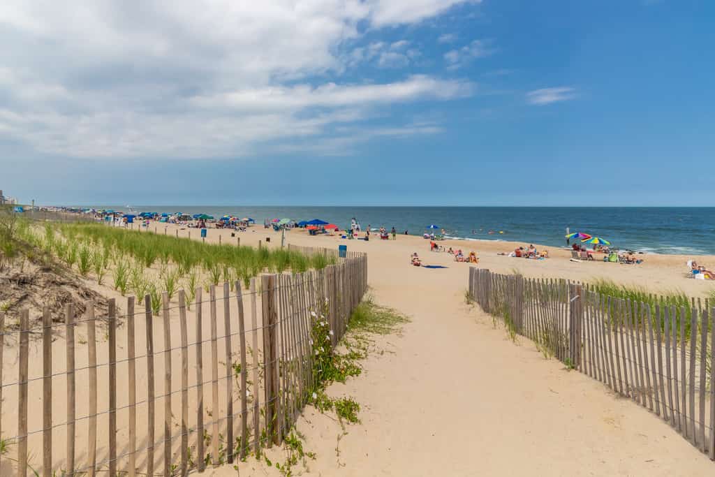 Sandy beach filled with people enjoying a beach day in Ocean City, MD