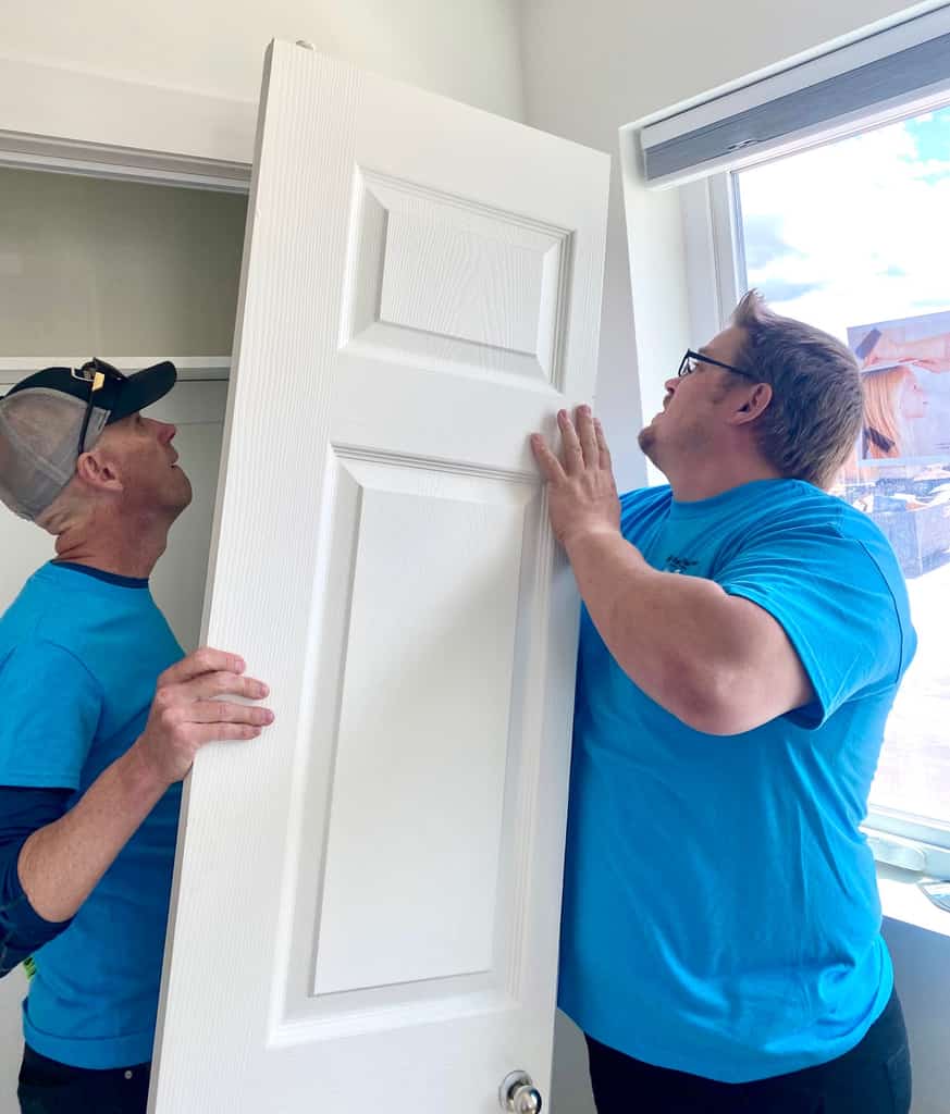 People installing a door.