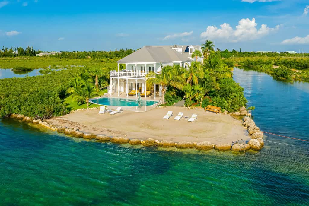 Large vacation home next to a canal with an outdoor pool.