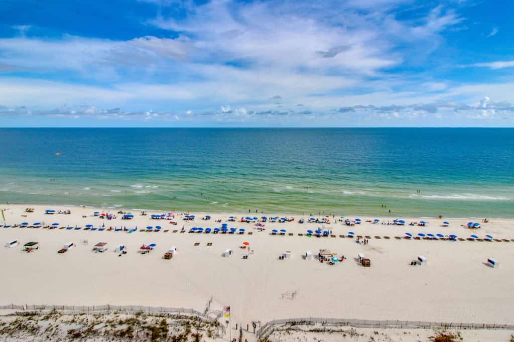 an arial view of beachgoers enjoying Orange Beach, AL.