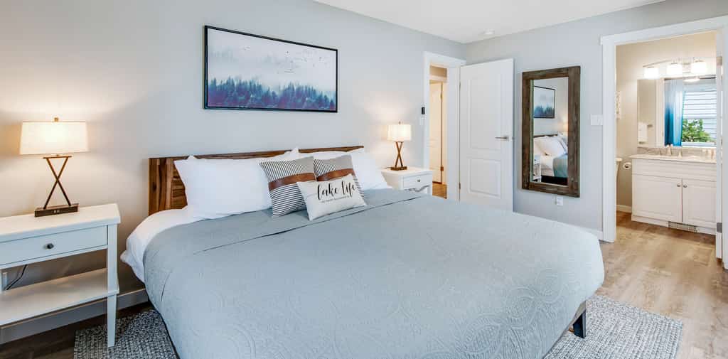 master bedroom with light blue bedding and throw pillows