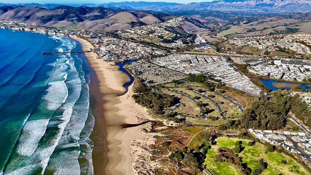 aerial view of pismo beach with the hills and mountains beyond the city