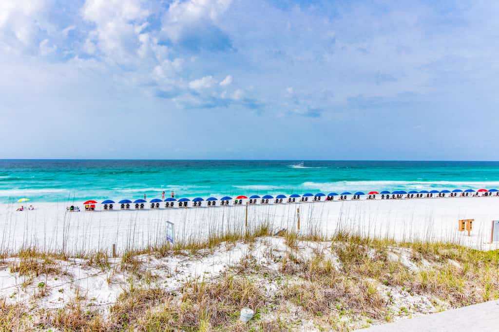 Beach with lounge chairs in Seaside, FL
