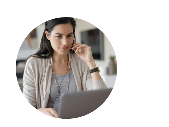 woman with headset staring at her laptop