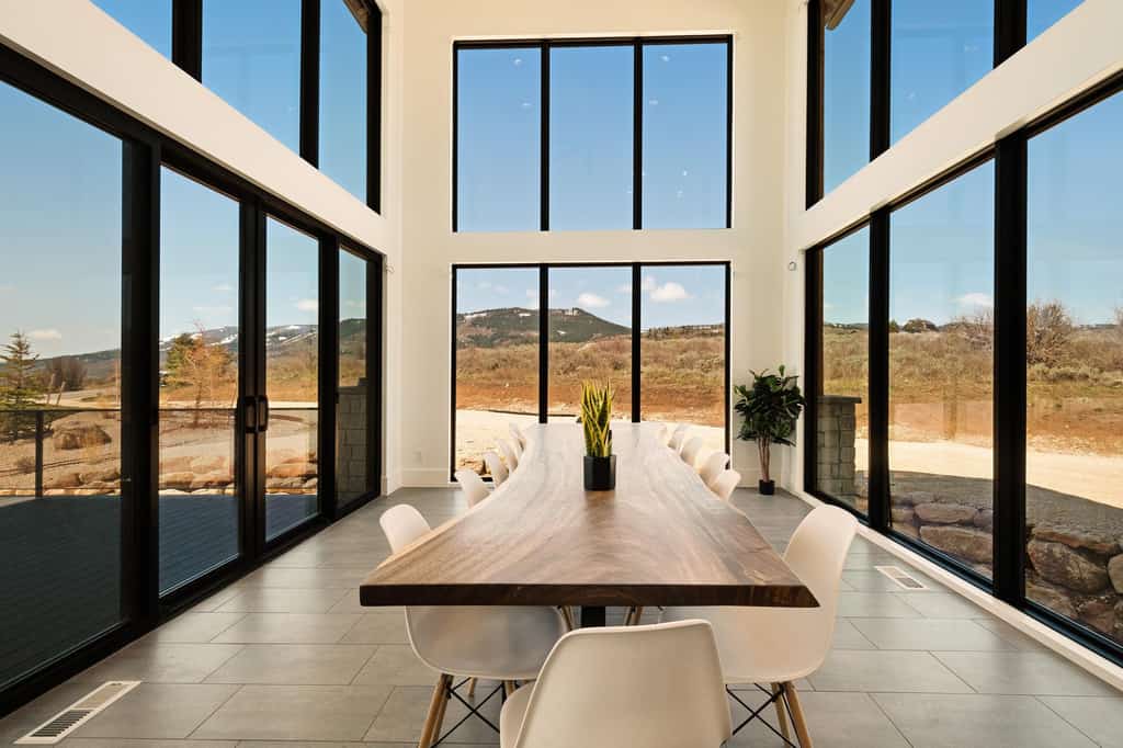 A large table in a sun encompassed room.