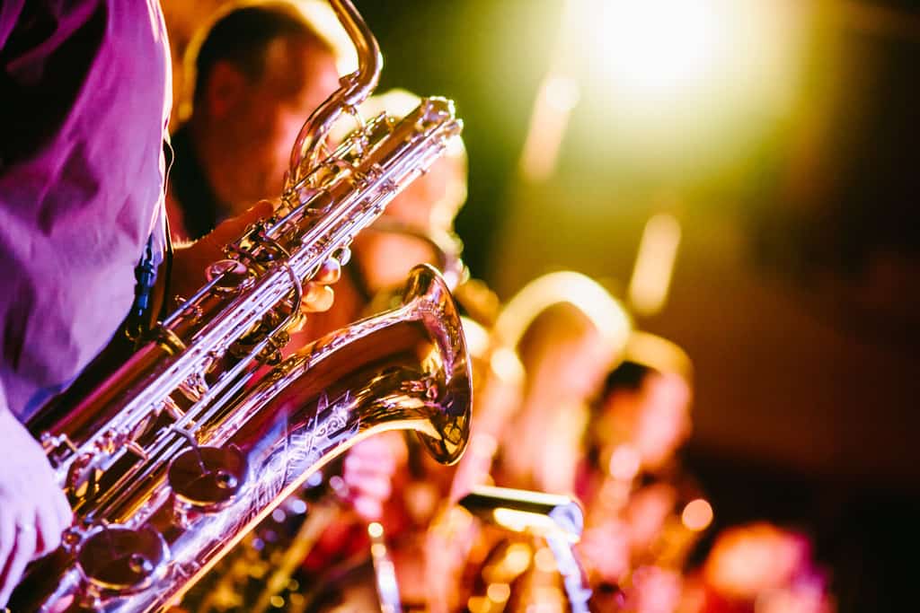 People playing jazz music with saxophones and other instruments.