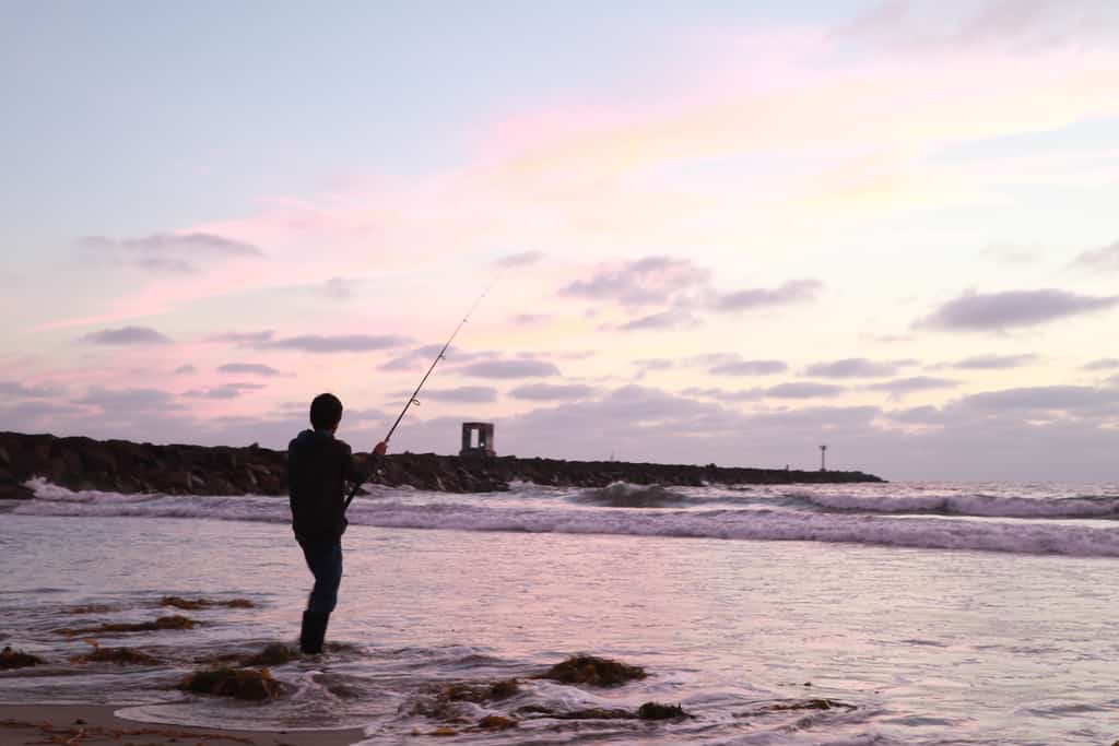 Photo of a man Ocean fishing on the coast of San Diego.