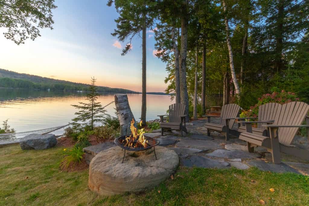 Lakefront vacation rental fire-pit with hammock and seating