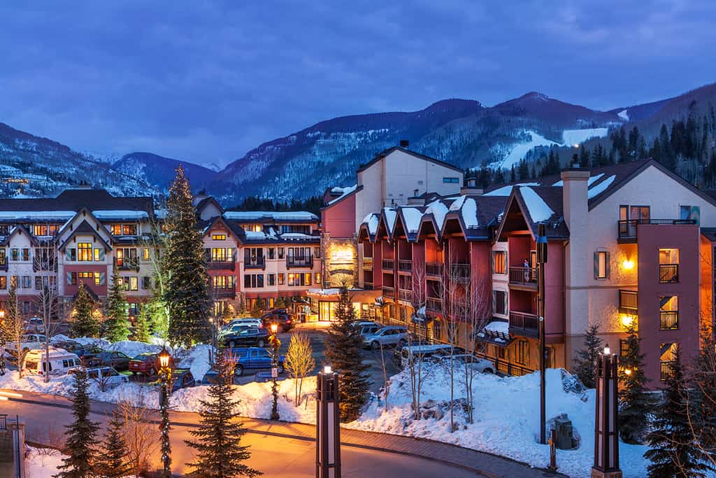 lion square lodge lit up at night in vail, co