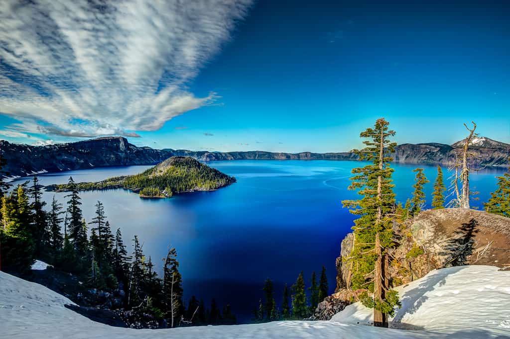 the snowy ground overlooking a view of Crater Lake, OR