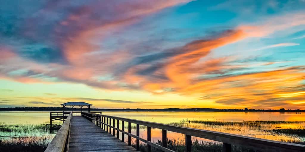 The colorful sky brightens up a dock over Lake Tohopekaliga, FL