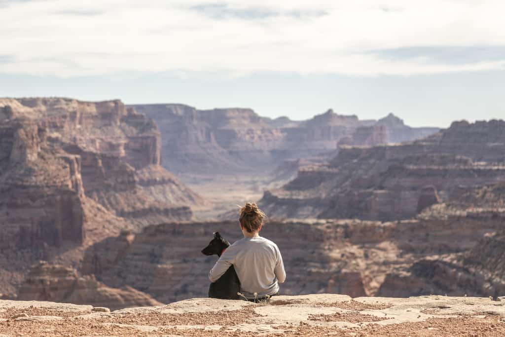 A woman with her dog at the Grand Canyon.