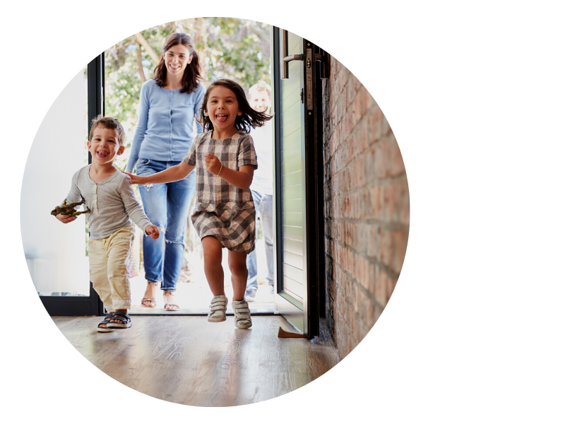 mother with kids walking in front door of vacation rental