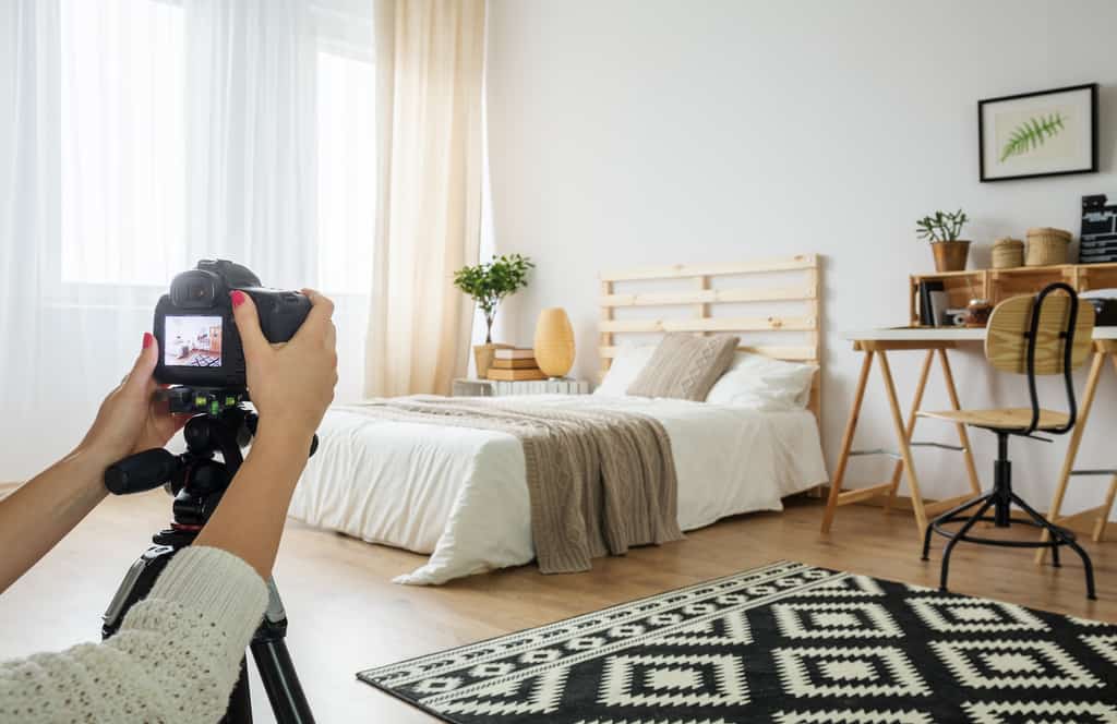 a professional photographer taking pictures of a bedroom