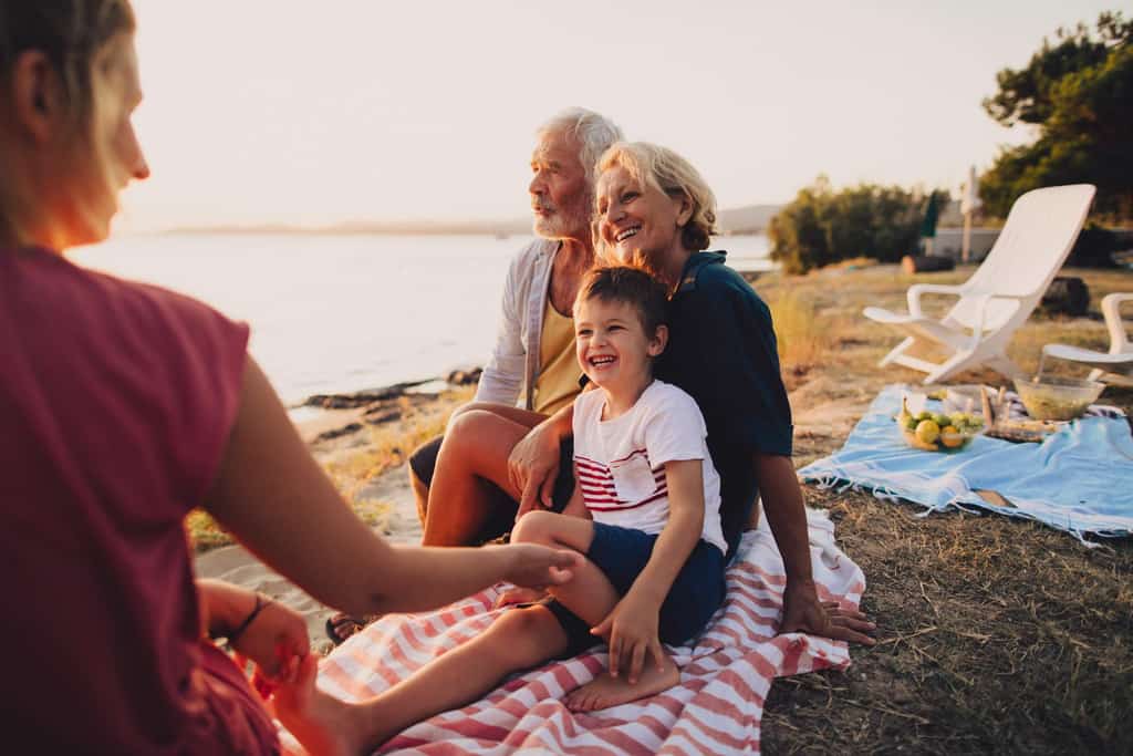 An older couple with their grandchild on the beach