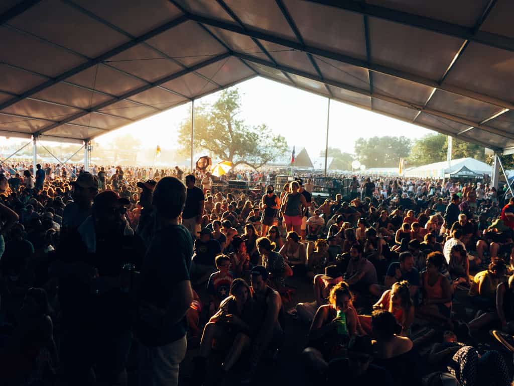 A large group of people sitting under a tent at Austin City Limits.